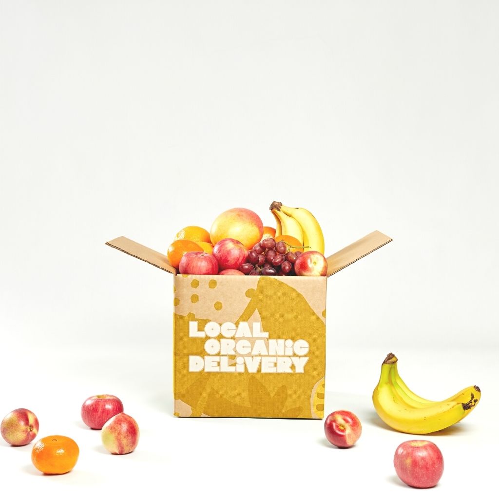 A beautiful organic fruit box from Local Organic Delivery, overflowing with a variety of fresh, seasonal, and delicious fruits.